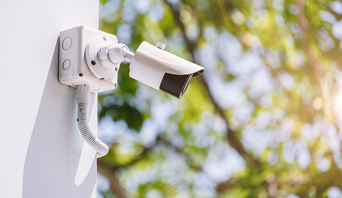 Outdoor bullet security camera on white wall