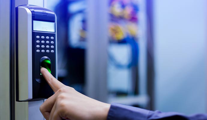 A person scanning their fingerprint on a biometric reader