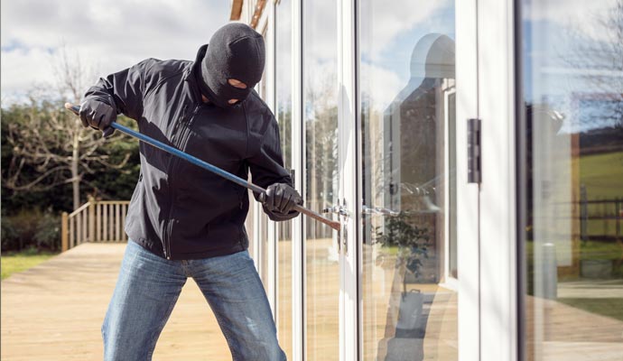 Burglar breaking glass door