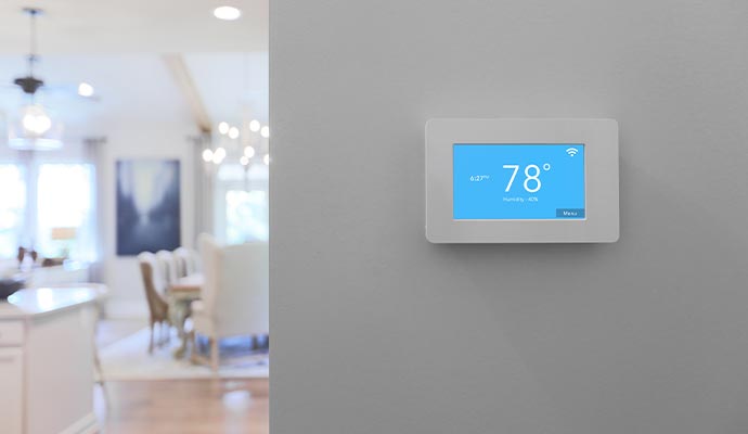 Home smart thermostat on wall