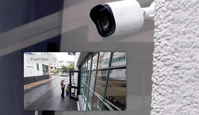 Outdoor security camera monitoring a building entrance.