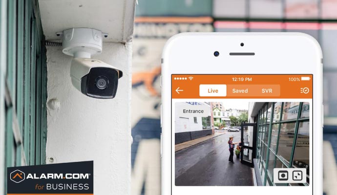 Smartphone showing live view from security camera of a retail store exterior