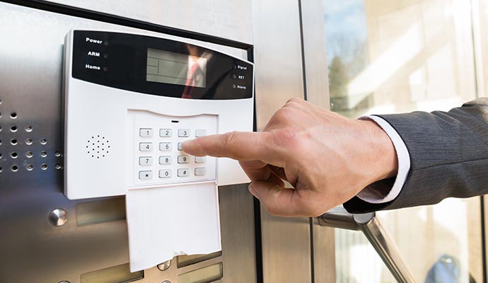 Entering access code commercial security panel.