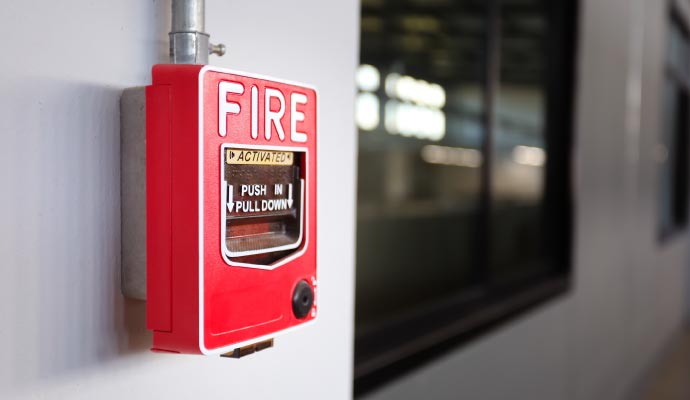 Fire alarm pull station mounted on a wall