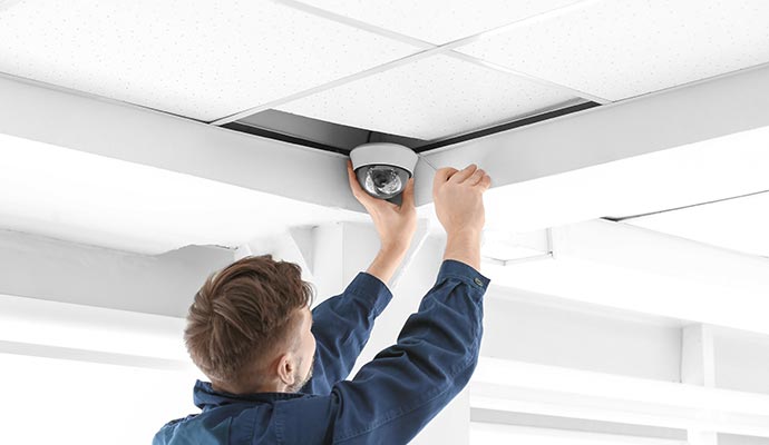 Man installation CCTV camera on selling