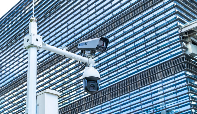 Municipal surveillance cameras installed outside a modern commercial building
