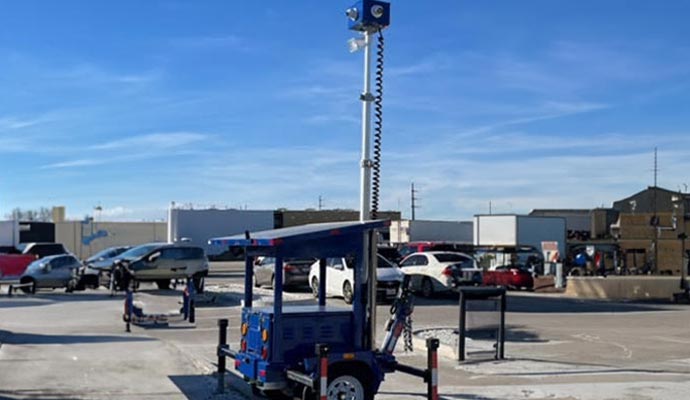Mobile security camera tower deployed in a parking lot.