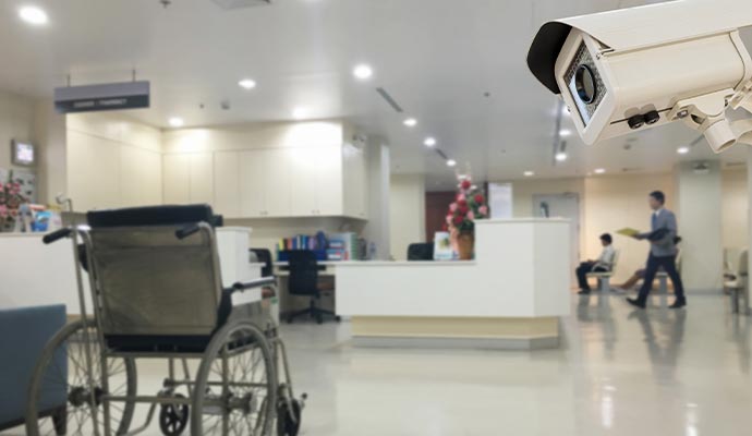 Security camera installed in hospital corridor for monitoring staff and patients